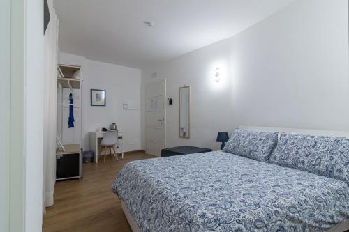 a bedroom with a bed and a table and a desk at Joseph's House Accommodation in Civitavecchia