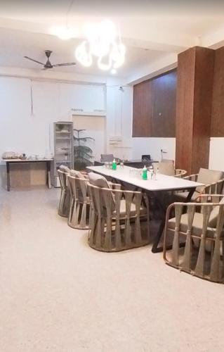 an empty room with a large table and chairs at Hotelthemarwarexcellency in Jodhpur