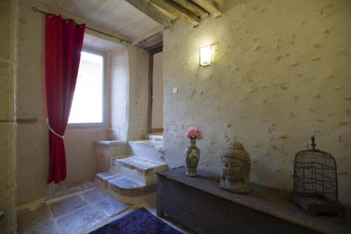 a room with stairs and a window and a bird cage at Le clos mélior in Lusignan