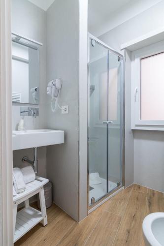 a bathroom with a glass shower and a sink at Joseph's House Accommodation in Civitavecchia