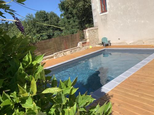 a swimming pool in front of a house at Les saules in Persac