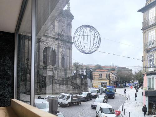 a view of a street with cars parked in front of a building at Clérigos Cinema Guesthouse in Porto