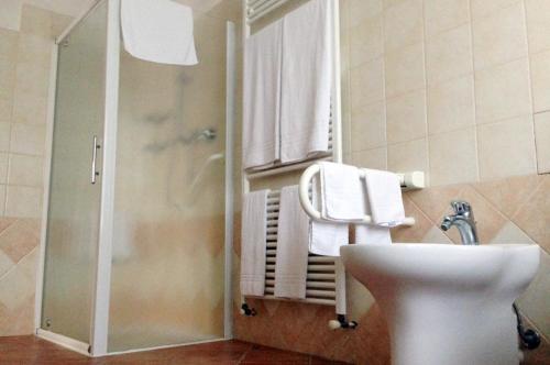 La salle de bains est pourvue de toilettes, d'un lavabo et d'une douche. dans l'établissement Casa Remussi, à Treiso