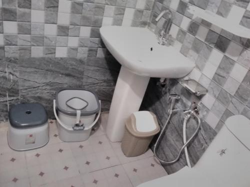 a bathroom with a sink and a toilet at Mount aura stay & Dine in Kanatal