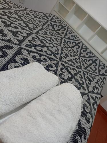 a bathroom with two white towels on a floor at Lezca in Concordia