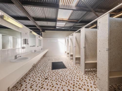 a bathroom with two sinks and two mirrors at BIG4 Townsville Gateway Holiday Park in Townsville