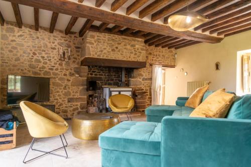 a living room with a blue couch and chairs at Le Grand Mesnil - Collection Idylliq in Pré-en-Pail
