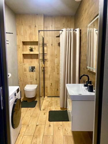 a bathroom with a toilet and a sink and a shower at Apartament KROPELKA in Piechowice