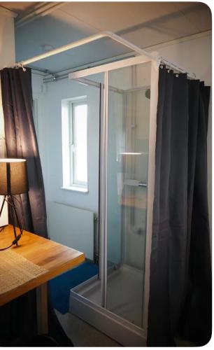 a glass cabinet in a room with a window at Northern Lights Apartment for Independent Stay in Jukkasjärvi