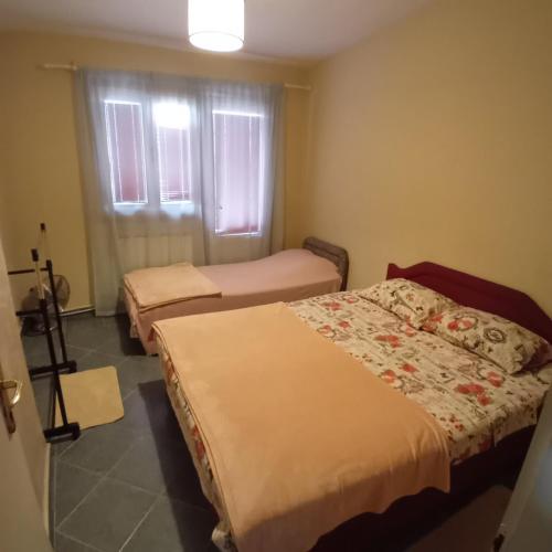 a room with two beds and a window at Podgorica apartment in Podgorica