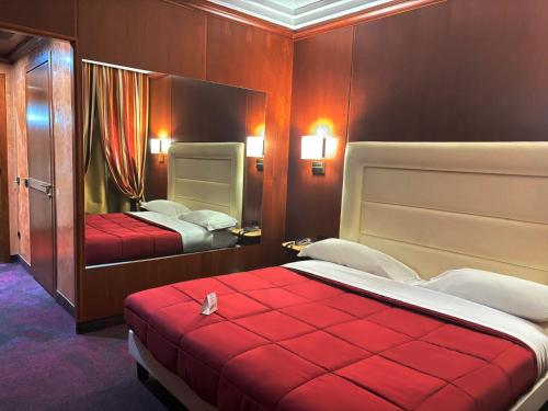 a hotel room with two beds with red covers at AS Hotel Monza in Monza