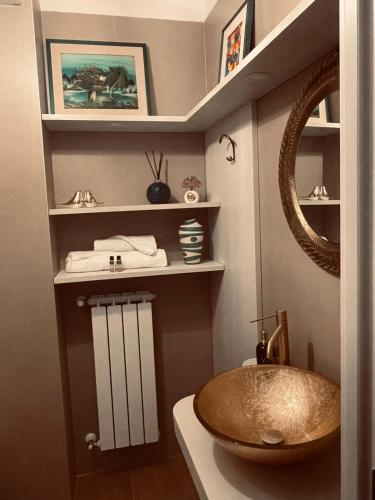 a bathroom with a sink and a mirror at Aleroom25 in Bari