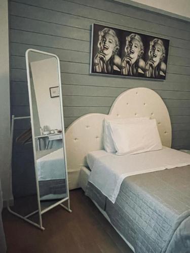 a bedroom with a mirror next to a bed at Aleroom25 in Bari
