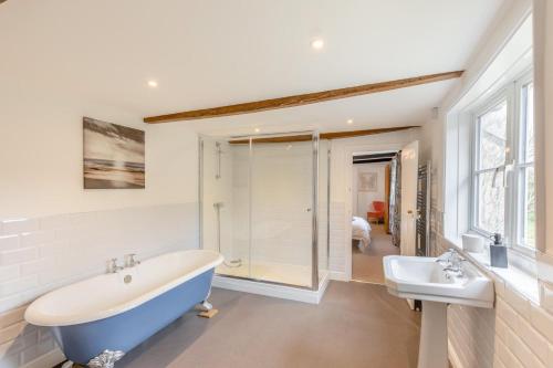 a bathroom with a large tub and a sink at 6 Bed in Docklow oc-d31042 in Docklow
