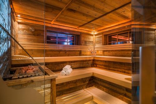 a bathroom with a sauna with wooden walls and floors at Hotel Wiese in Sankt Leonhard im Pitztal