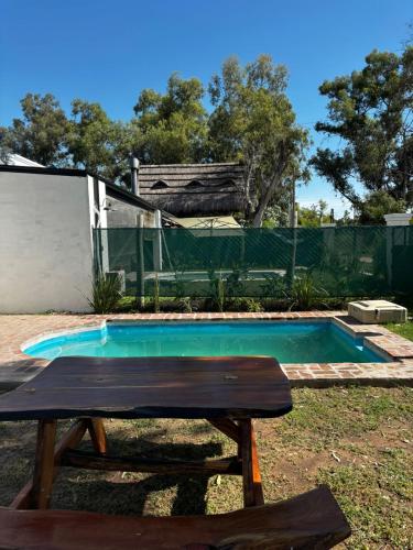 a picnic table in front of a swimming pool at Rincon de Tucuns in San José del Rincón