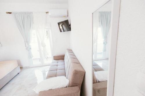 a living room with a couch and a mirror at Villa Theano 2 in Toroni