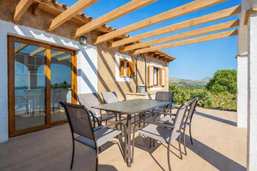 a patio with a table and chairs on a balcony at Ca na Moli in Artá