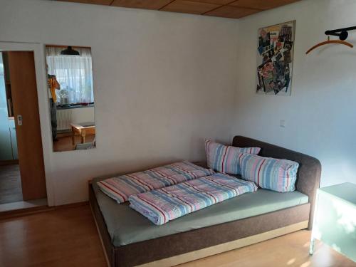 a couch with pillows on it in a room at Ferienzimmer Muns in Annaberg-Buchholz