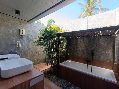 a bathroom with a bath tub and a sink at Anita dream house in Khao Sok National Park