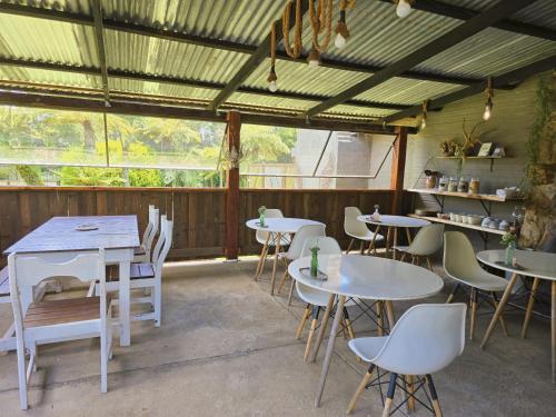 a room with tables and chairs in a building at Rustique in Graskop