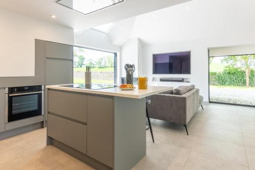 a kitchen with a large island and a couch at The Studio at Cherry Tree in Natland