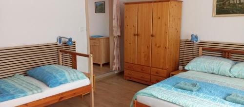 a bedroom with two bunk beds and a cabinet at Ubytování Lumik in Jeseník