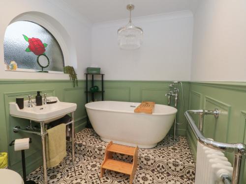 a bathroom with a white tub and a sink at Moorview in Holmfirth