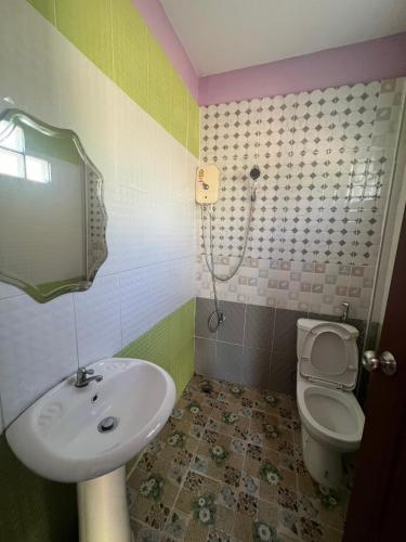 a bathroom with a sink and a toilet at Martin, Local Guide & Camping in Ban Phang Kan Nua
