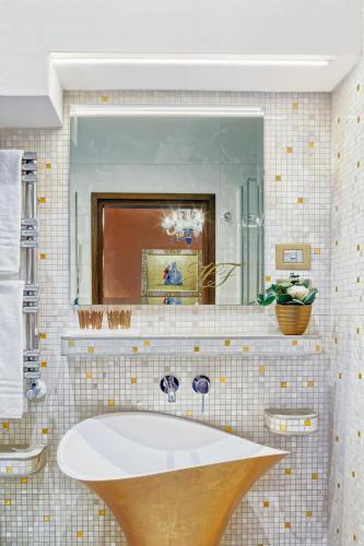 a bathroom with a sink and a mirror at Hotel Firenze in Venice