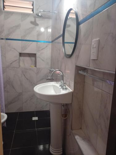 a bathroom with a sink and a mirror at Cabañas los Materos 3 in Santa María