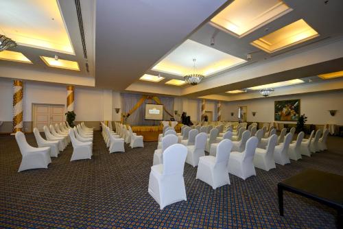 a room with rows of white chairs and a podium at Stella Di Mare Beach Hotel & Spa in Sharm El Sheikh