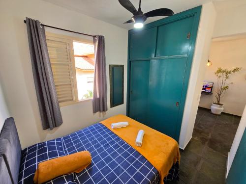 a bedroom with a blue bed and a green cabinet at Jaboticabal 403A in Jabuticabal