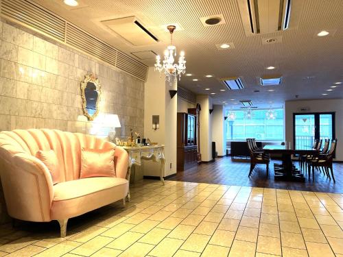 a living room with a couch and a table at Hotel Il Viale Hachinohe Annex in Hachinohe