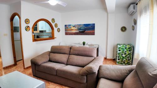a living room with a couch and a table at Apartalux Zen Pacific in El Cabo de Gata