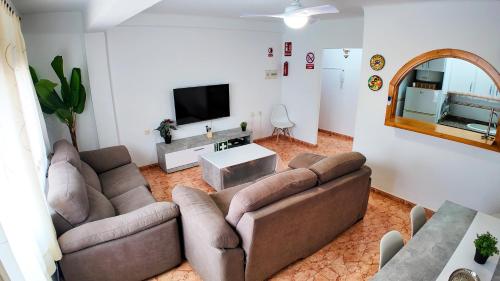 a living room with two couches and a flat screen tv at Apartalux Zen Pacific in El Cabo de Gata
