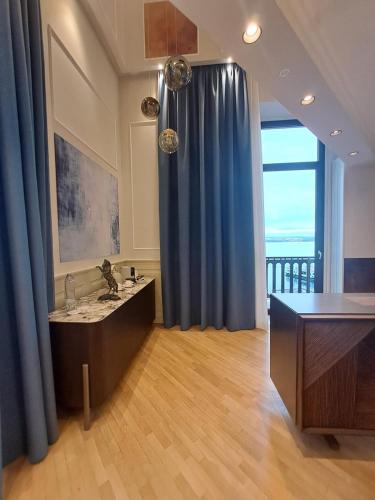 a room with a blue curtain and a desk at Hotel Europa in Taranto