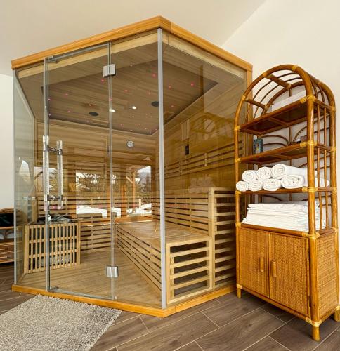a room with a bunk bed with glass walls at Brauer Panzió in Mecseknádasd