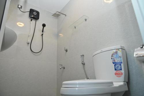a bathroom with a white toilet and a shower at French Villa in Dankotuwa