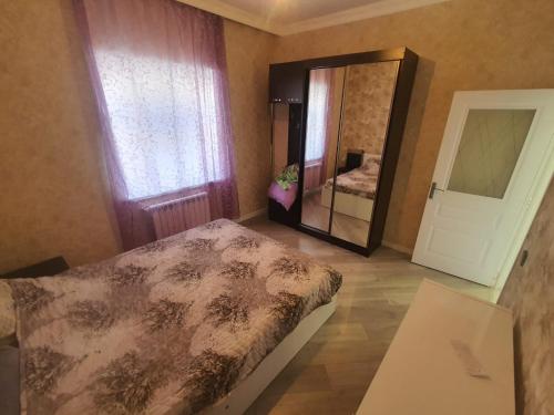 a bedroom with a bed and a large mirror at dlb VILLA 2 in Baku