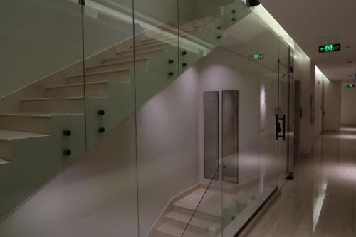 a staircase in a room with a glass wall at Albateel 2 Serviced Apartments-اقتصادي in Riyadh