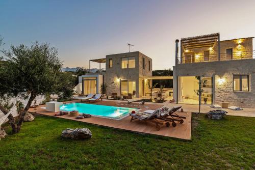 a house with a swimming pool in the yard at Annassa Experience Villa 2' walk from Almyrida beach in Almyrida