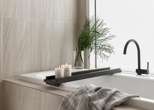 a bathroom with a bath tub with two candles at Arctic TreeHouse Hotel in Rovaniemi