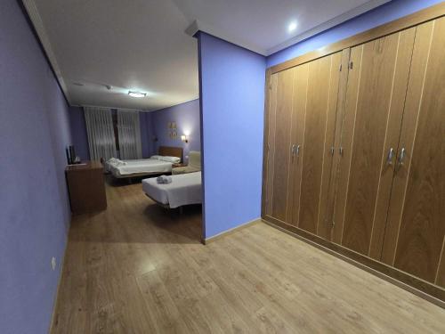 a room with a room with cabinets and a room with a room at HOTEL EL ROBLE PALENTINO in Cervera de Pisuerga