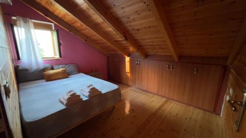 a bedroom with a bed with towels on it at The Mountain Attic in Përmet
