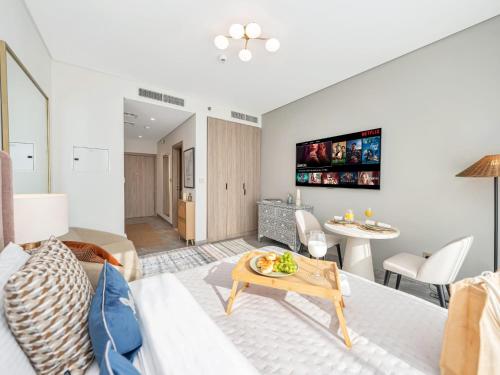 a living room with a couch and a table at Peninsula One Suites by Prestige Nest in Dubai