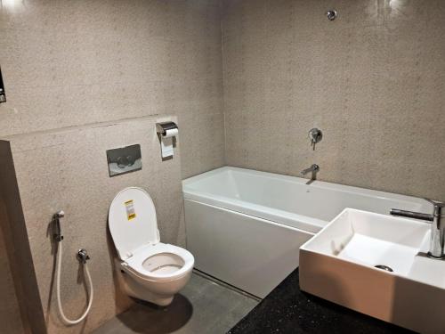 a bathroom with a toilet and a sink at Hotel Sagar Sonnet in Haldia