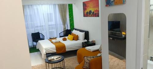 a hotel room with a bed and a tv at Elite Homes furnished Studio near JKIA in Syokimau