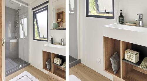 a bathroom with two sinks and a mirror at Camping le Laha in Lesperon