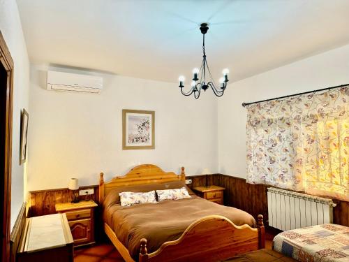a bedroom with a bed and a chandelier at Los Jabones in Ciudad Real